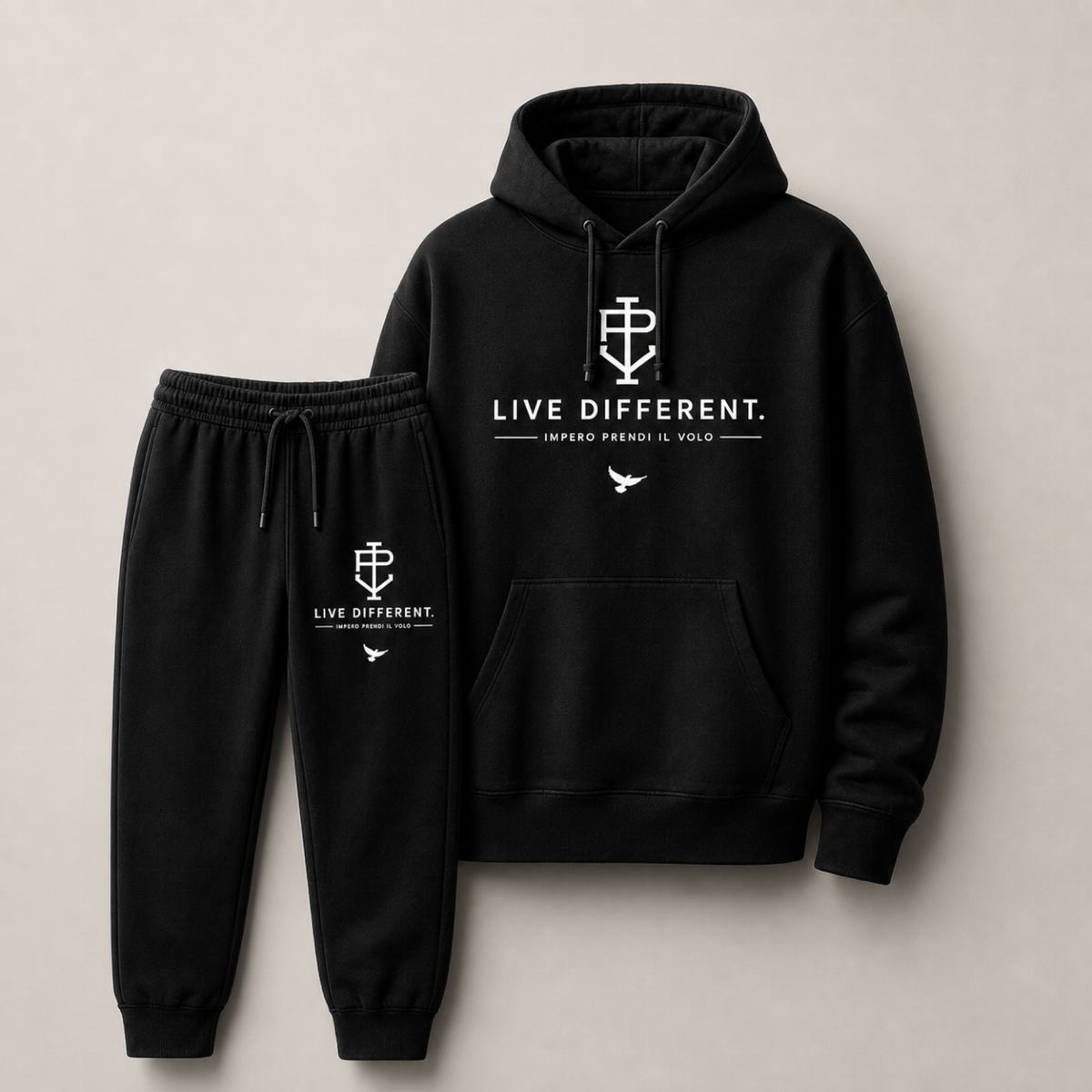 A black two-piece tracksuit set consisting of a pullover hoodie and matching jogger pants, both featuring white printed graphics and text on the chest and thigh. The hoodie displays 'LIVE DIFFERENT.