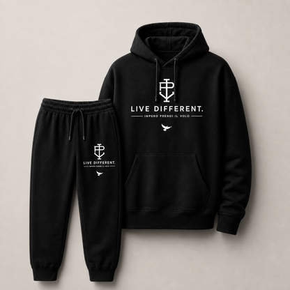 A black two-piece tracksuit set consisting of a pullover hoodie and matching jogger pants, both featuring white printed graphics and text on the chest and thigh. The hoodie displays 'LIVE DIFFERENT.